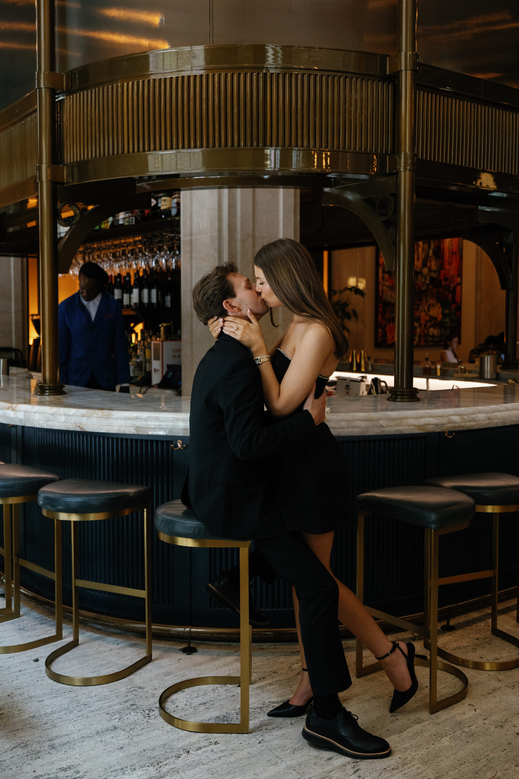 Editorial style engagement photo of couple at the Detroit Book Tower Bar