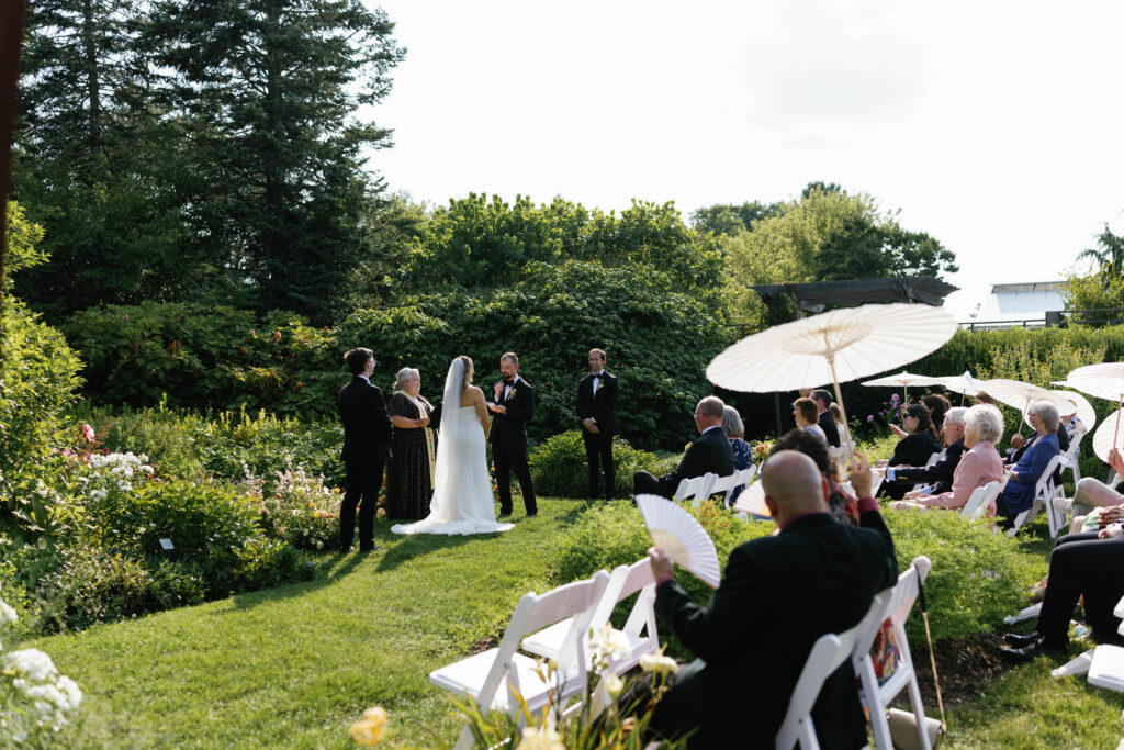 Bride and groom during ceremony at Matthaei Botanical Garden
