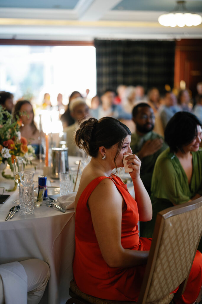 wedding guest wiping tear during reception speech