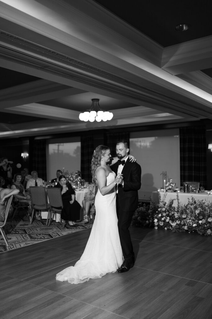 Black and white image of bride and grooms first dance.
