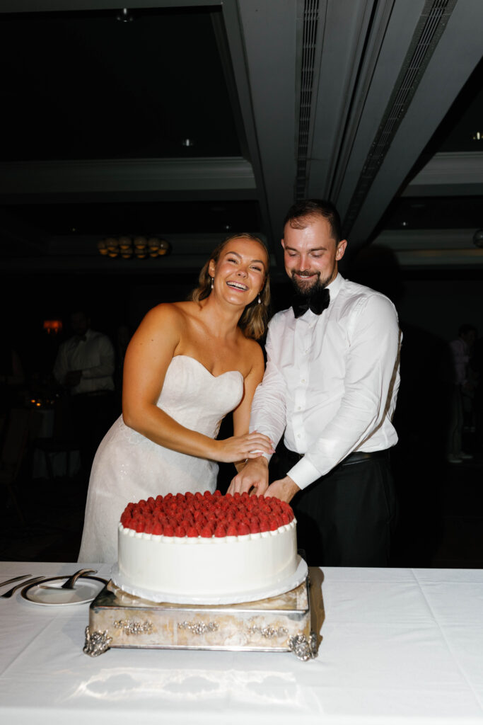 Bride and groom cutting their wedding cake.