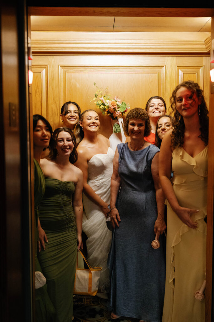 Bride and bridesmaids in elevator at the graduate hotel in Ann Arbor Michigan.