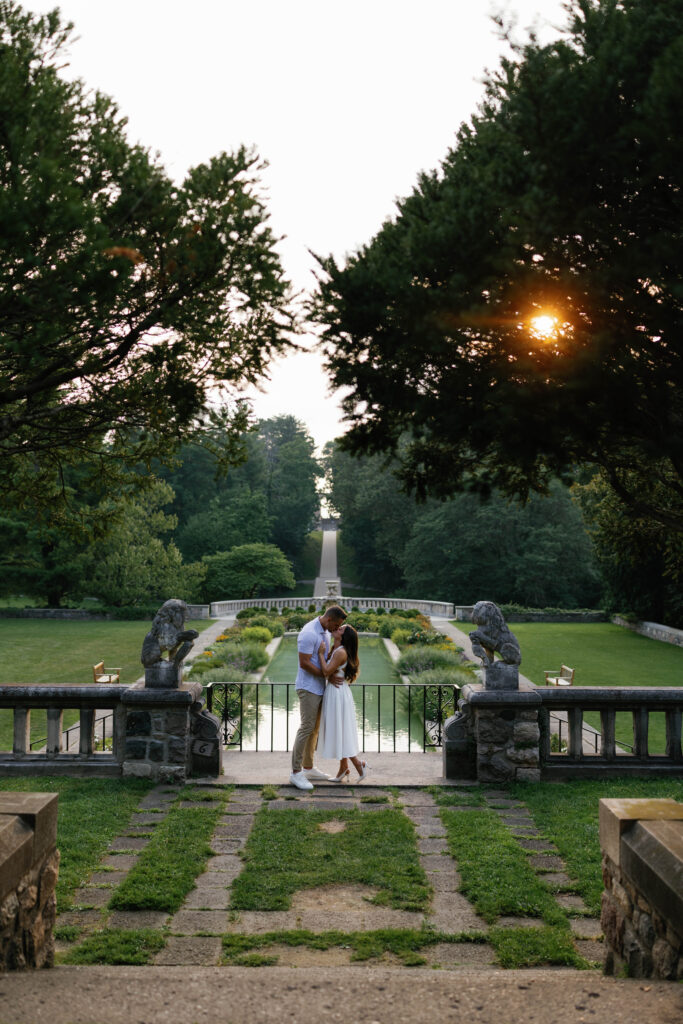 Couple looking at each other on the balcony overlooking reflection pool at Cranbrook House & Gardens.