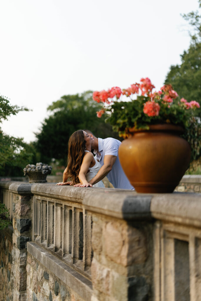 Romantic kiss on stone railing at Cranbrook House & Gardens in Detroit.