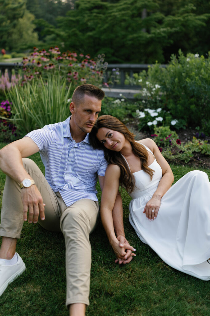 Editorial-style couple portrait sitting in formal gardens at Cranbrook House in Detroit.