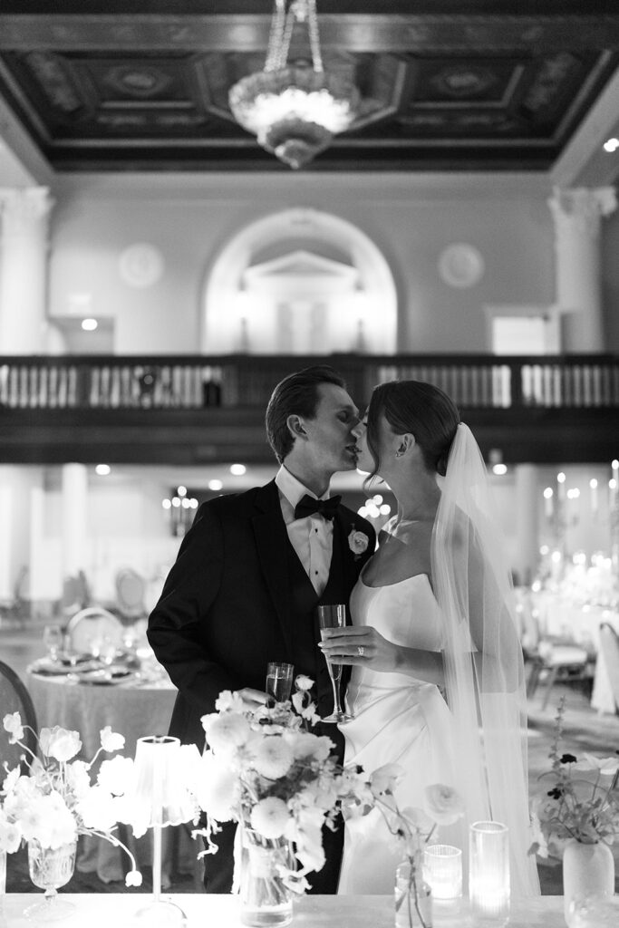 Romantic black and white photo of bride and groom sharing a kiss during their Amway Grand Plaza wedding reception