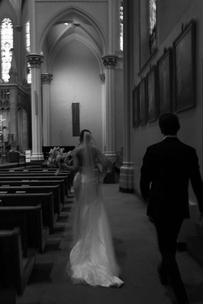 Bride and groom walking down the aisle after ceremony at St. Alphonsus Church in Grand Rapids before their Amway Grand Plaza wedding reception