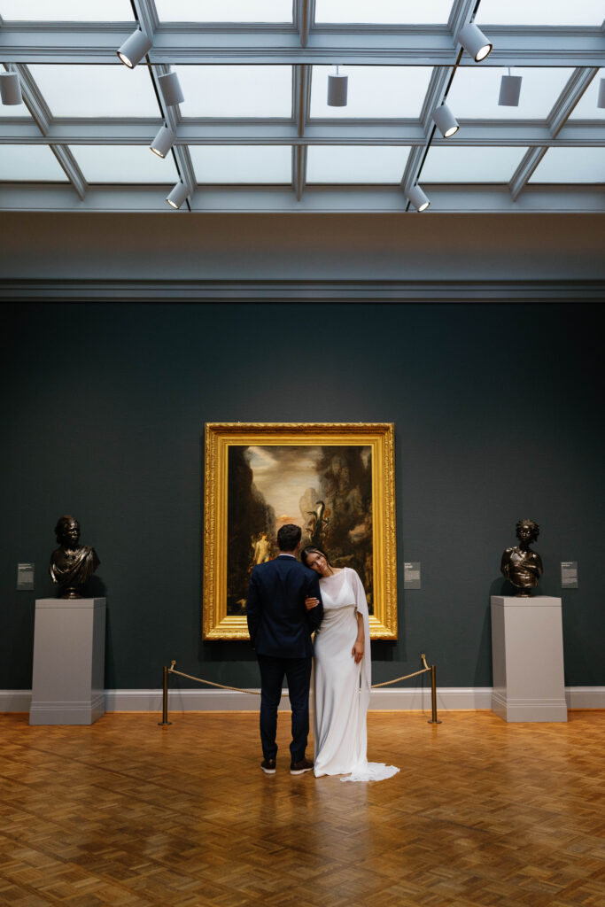 Chicago engagement photos couple at Art Institute gallery standing in front of artwork