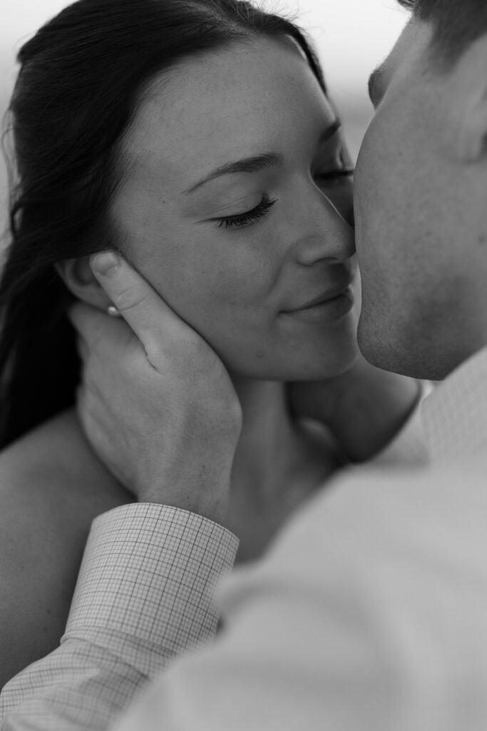 Chicago engagement photos lakefront black and white bride face being held by groom's in a close-up