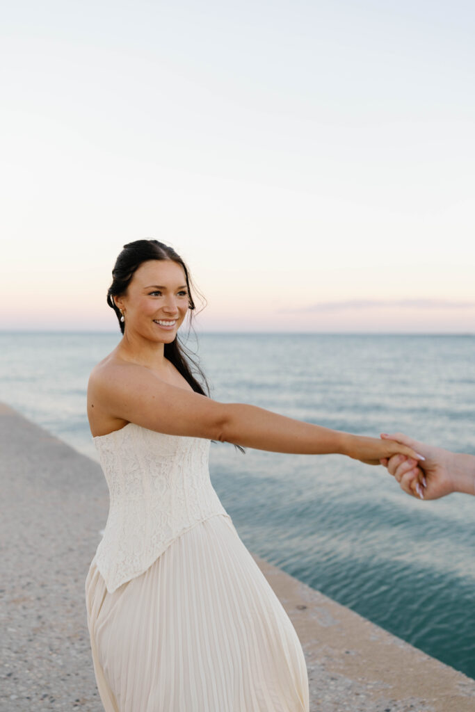 Lake Michigan Chicago engagement session bride dancing with groom