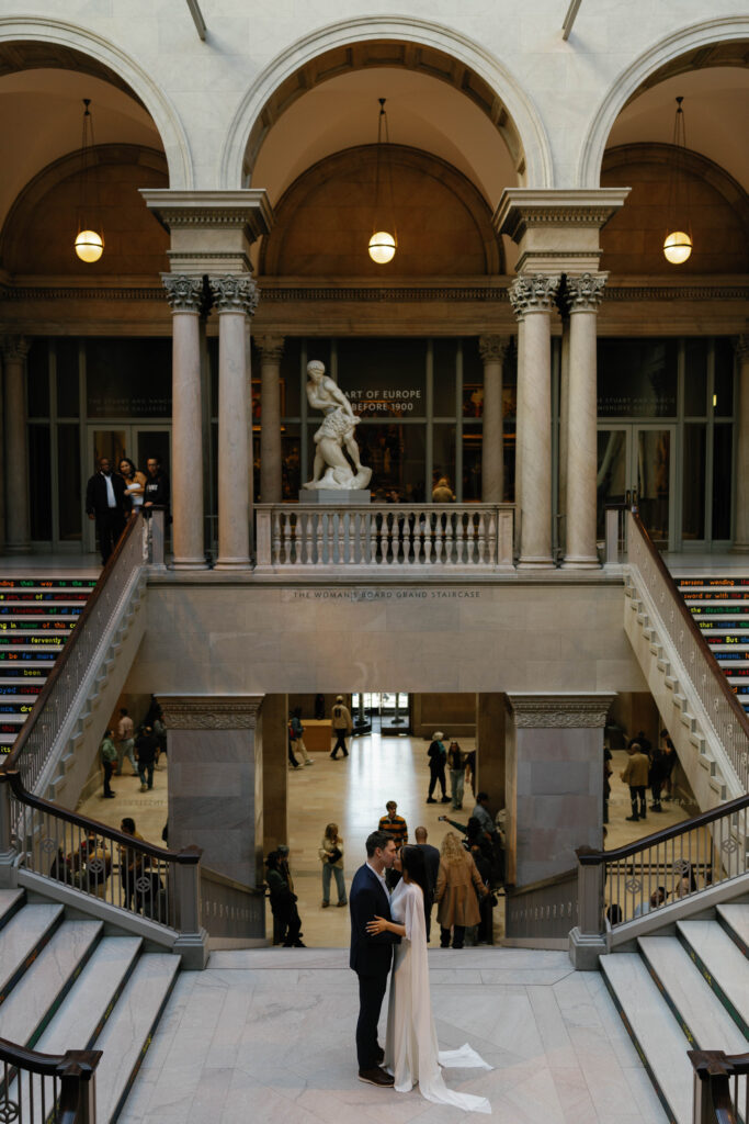 Art Institute Chicago engagement session romantic kiss on iconic grand staircase