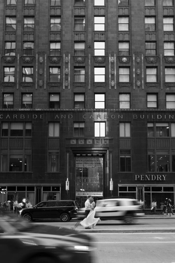 Chicago engagement photos black and white couple kissing Michigan Avenue median with motion blur