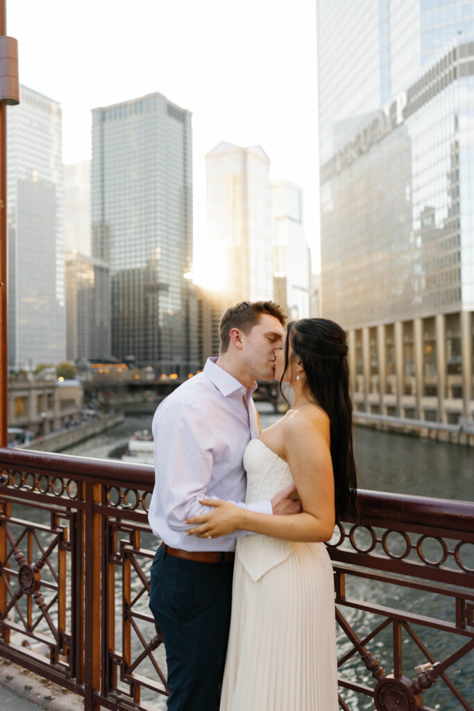 Chicago engagement photos couple kissing on Michigan Avenue Bridge with Chicago River background